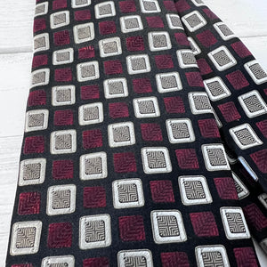 Patterned tie with geometric design on a wooden surface