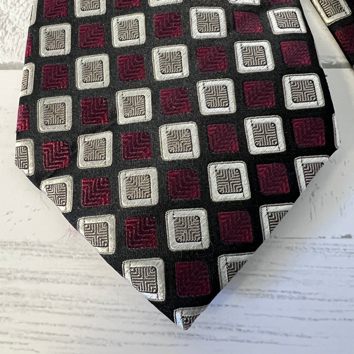 Patterned tie with geometric design on a white background