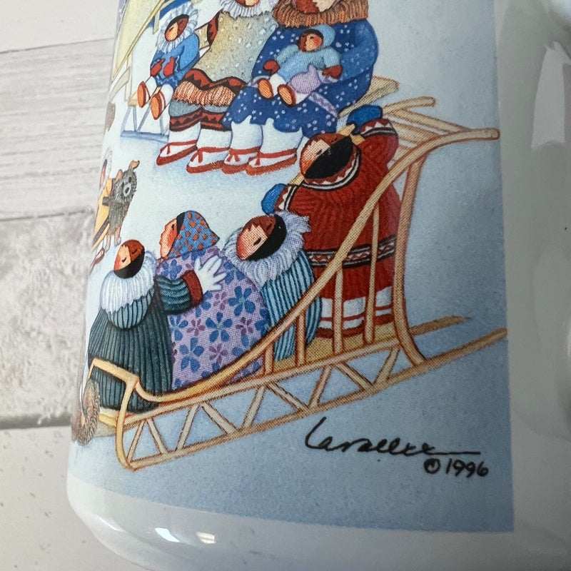Ceramic mug with a winter scene illustration of people on a sled, featuring a signature and year.