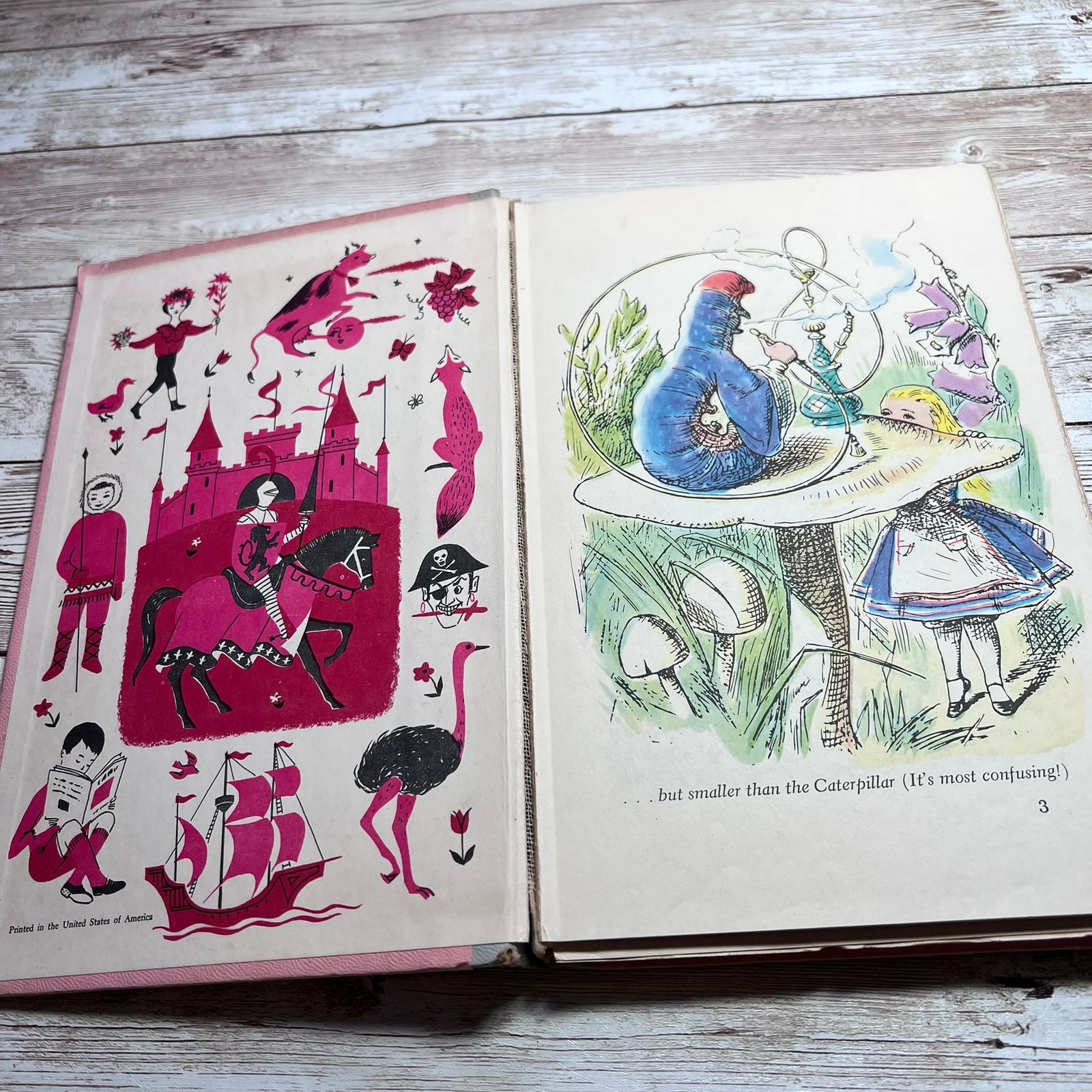 An open vintage children's book laid flat on a weathered wood surface, showing illustrated pages with whimsical drawings including a castle, a blue bird, a girl in a blue dress, and small black-and-white figures.