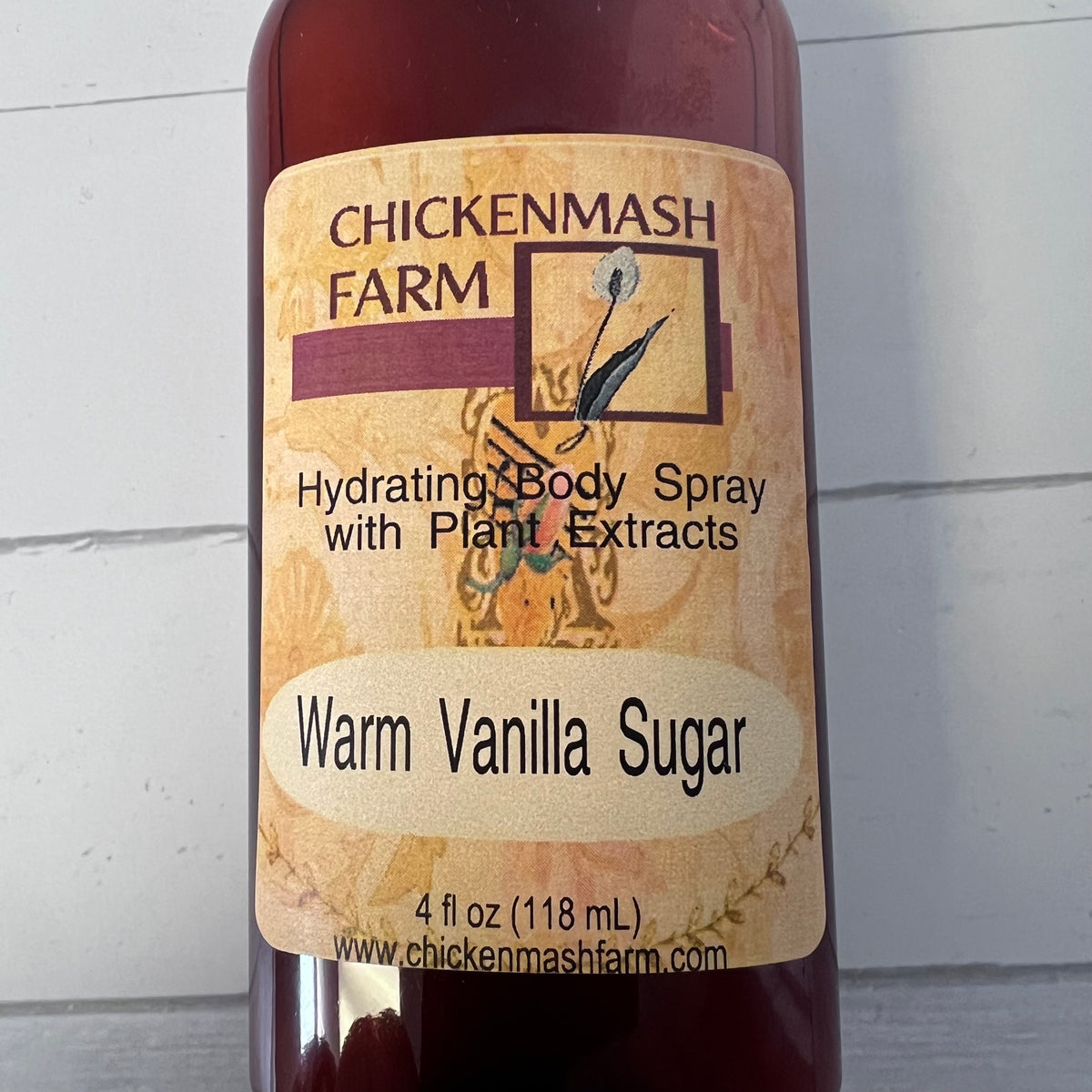 Bottle of Chickenmash Farm Warm Vanilla Sugar body spray on a light background