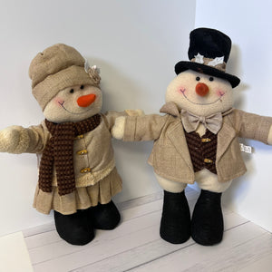 Two decorative snowmen dressed in winter clothing on a white background