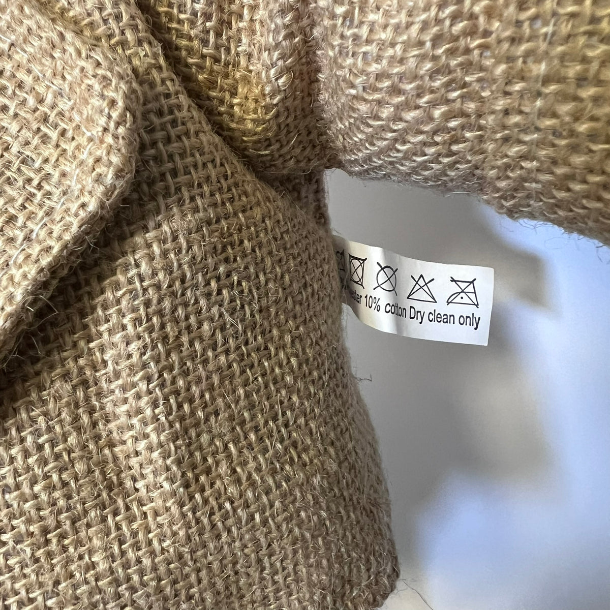 Close-up of a fabric texture with a care label on a blurred background