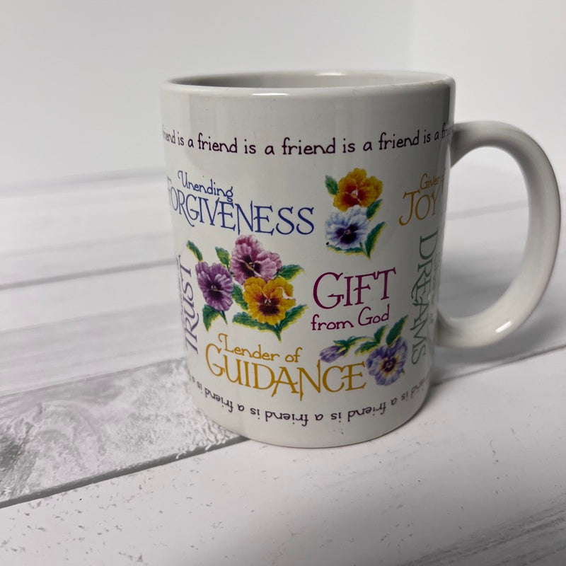 White mug with floral designs and text on a white background