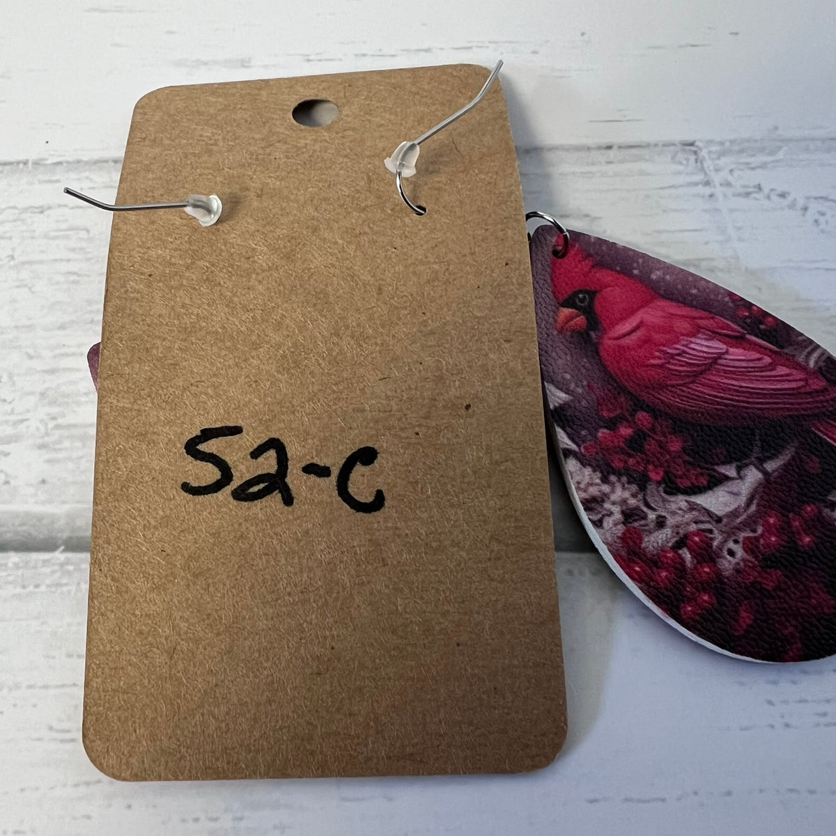 Brown tag with '52-C' on a white surface with a patterned object.