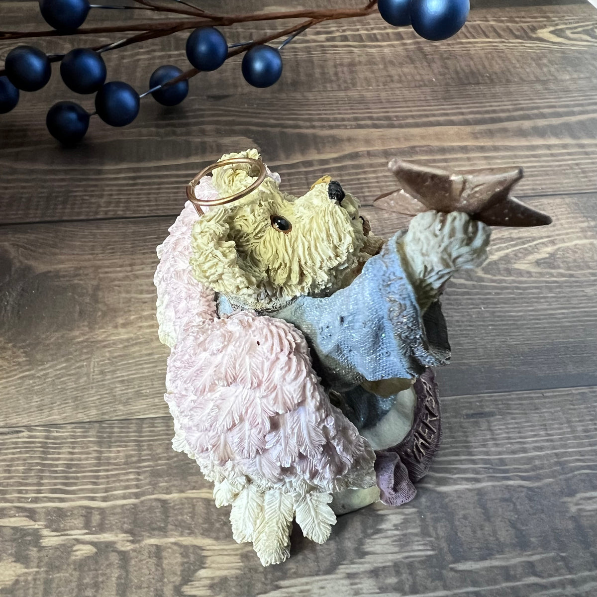 Decorative bear piece with a star on a wooden surface