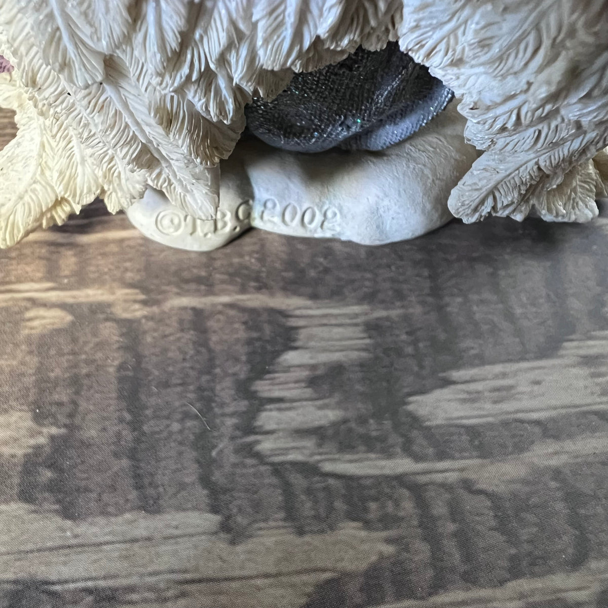 Decorative stone sculpture with a textured surface on a wooden floor.