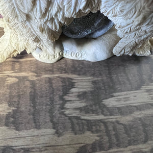 Decorative stone sculpture with a textured surface on a wooden floor.