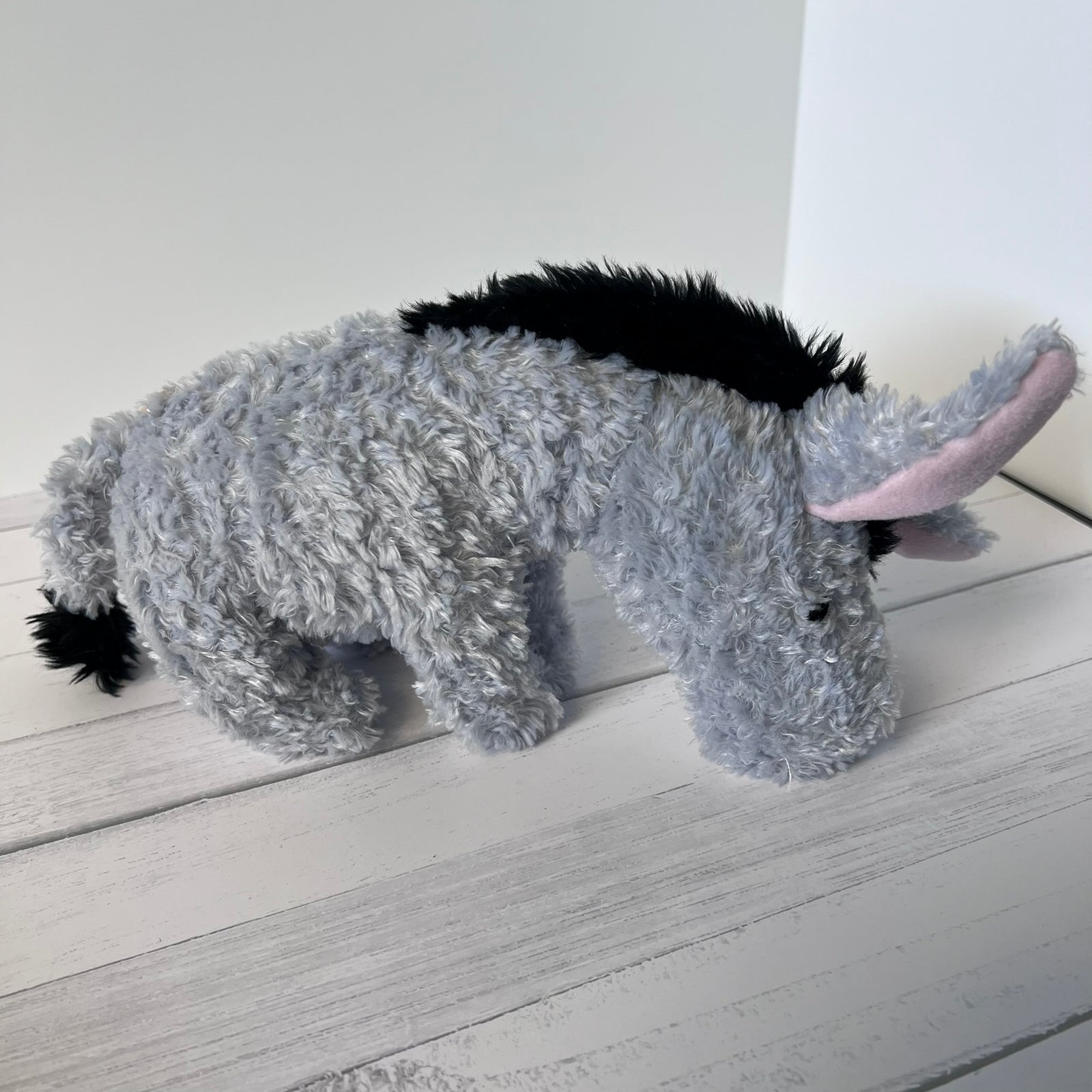 Plush donkey toy on a light wooden surface