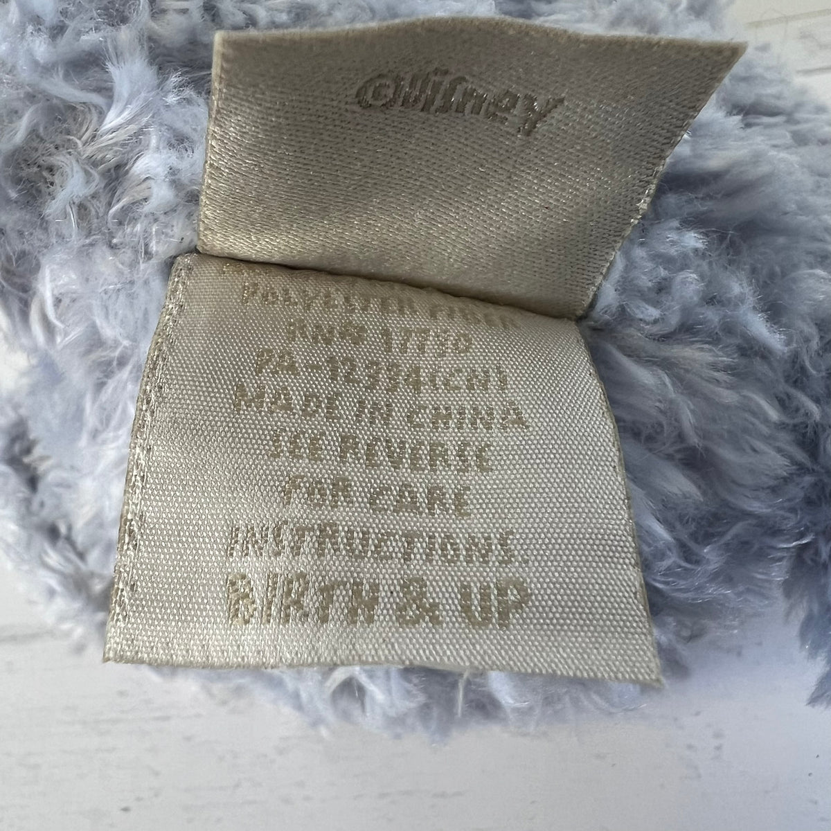 Textile label with 'Oxbow' branding on a textured gray background