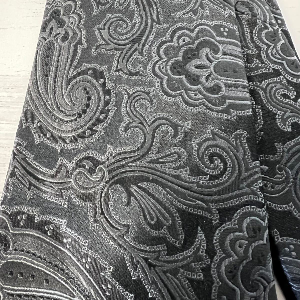 Close-up of a black and gray patterned fabric with intricate designs.