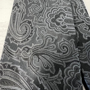 Close-up of a black and gray patterned fabric with intricate designs.