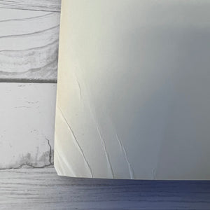 Close-up of a textured white surface with a blurred background