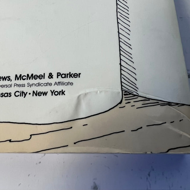 Close-up of a paper cutout with text and a geometric design on a white background.