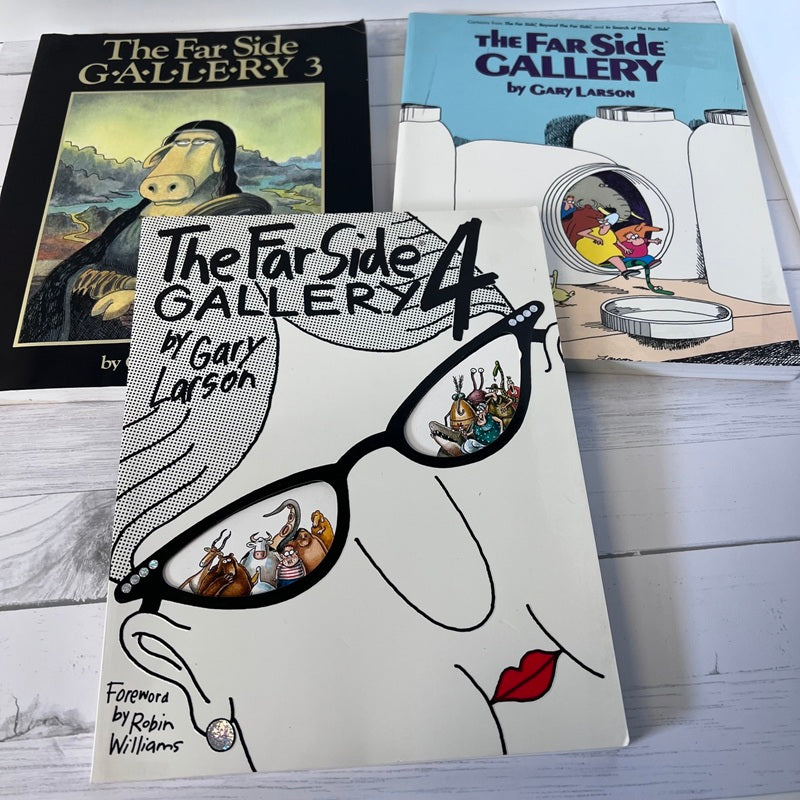 Three books from 'The Far Side Gallery' series by Gary Larson on a wooden surface.