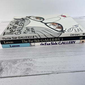 Two books titled 'The Far Side GALLERY' by Larson on a white surface.