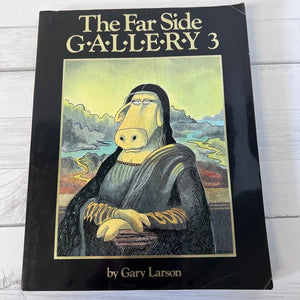 Book titled 'The Far Side Gallery 3' by Gary Larson on a wooden surface