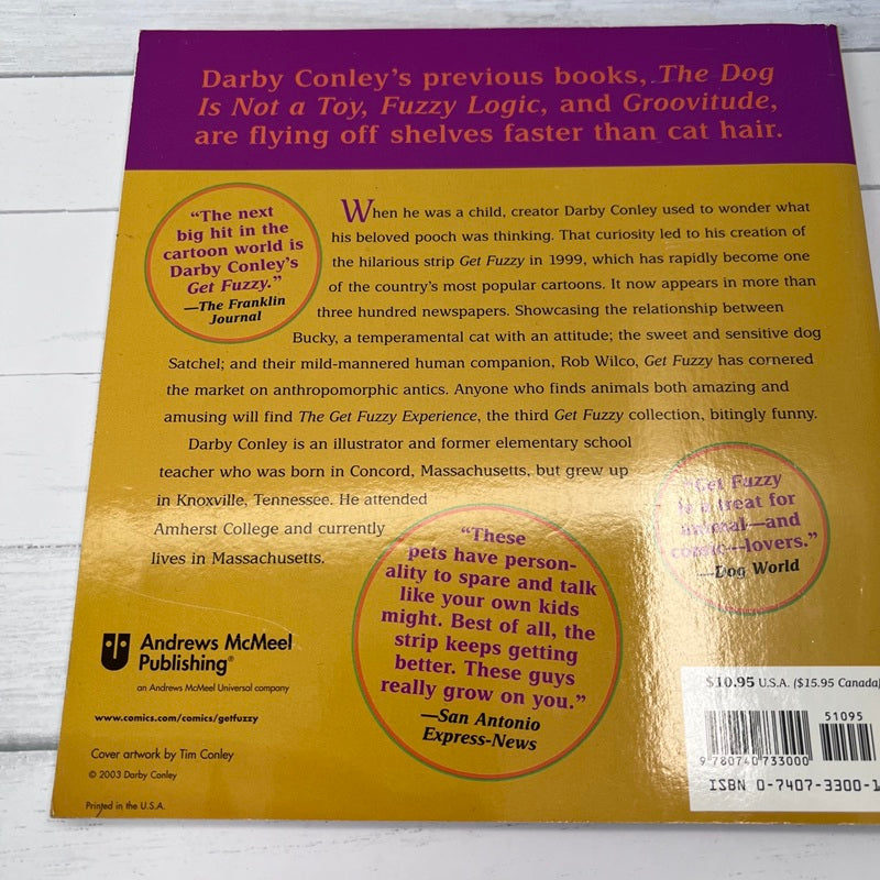 Back cover of a book with text and branding on a wooden surface