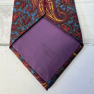 Purple pocket square with a patterned border on a light gray background