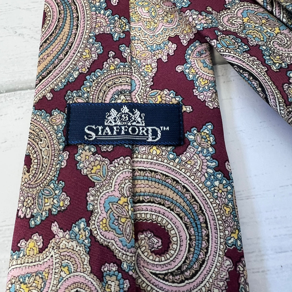 Patterned tie with Stafford label on a white background