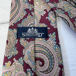 Patterned tie with Stafford label on a white background