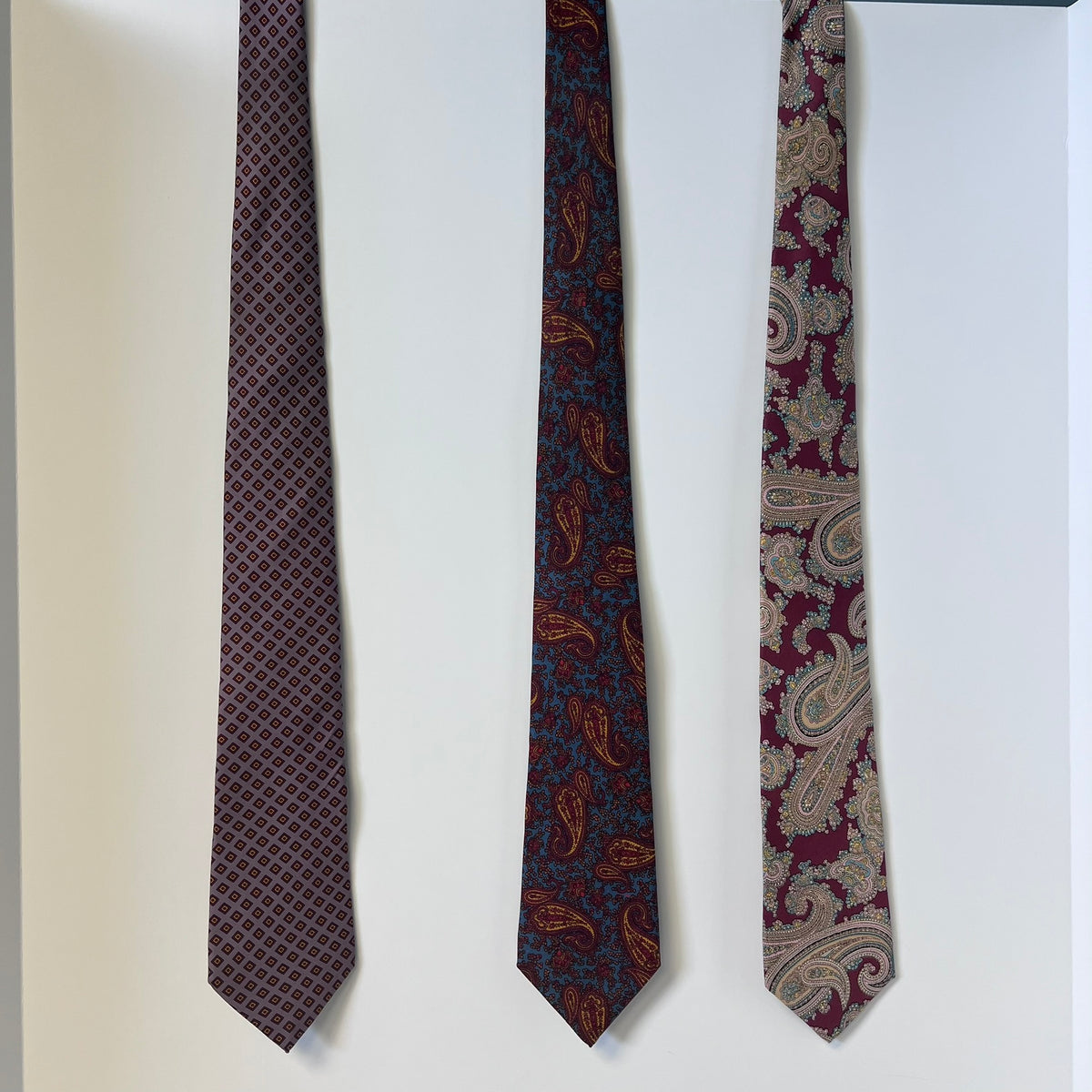 Three patterned ties on a white background