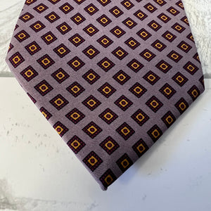 Patterned tie on a textured white surface