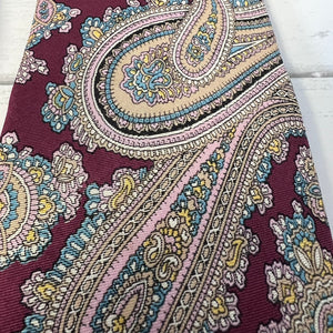 Close-up of a patterned fabric with intricate designs on a white background