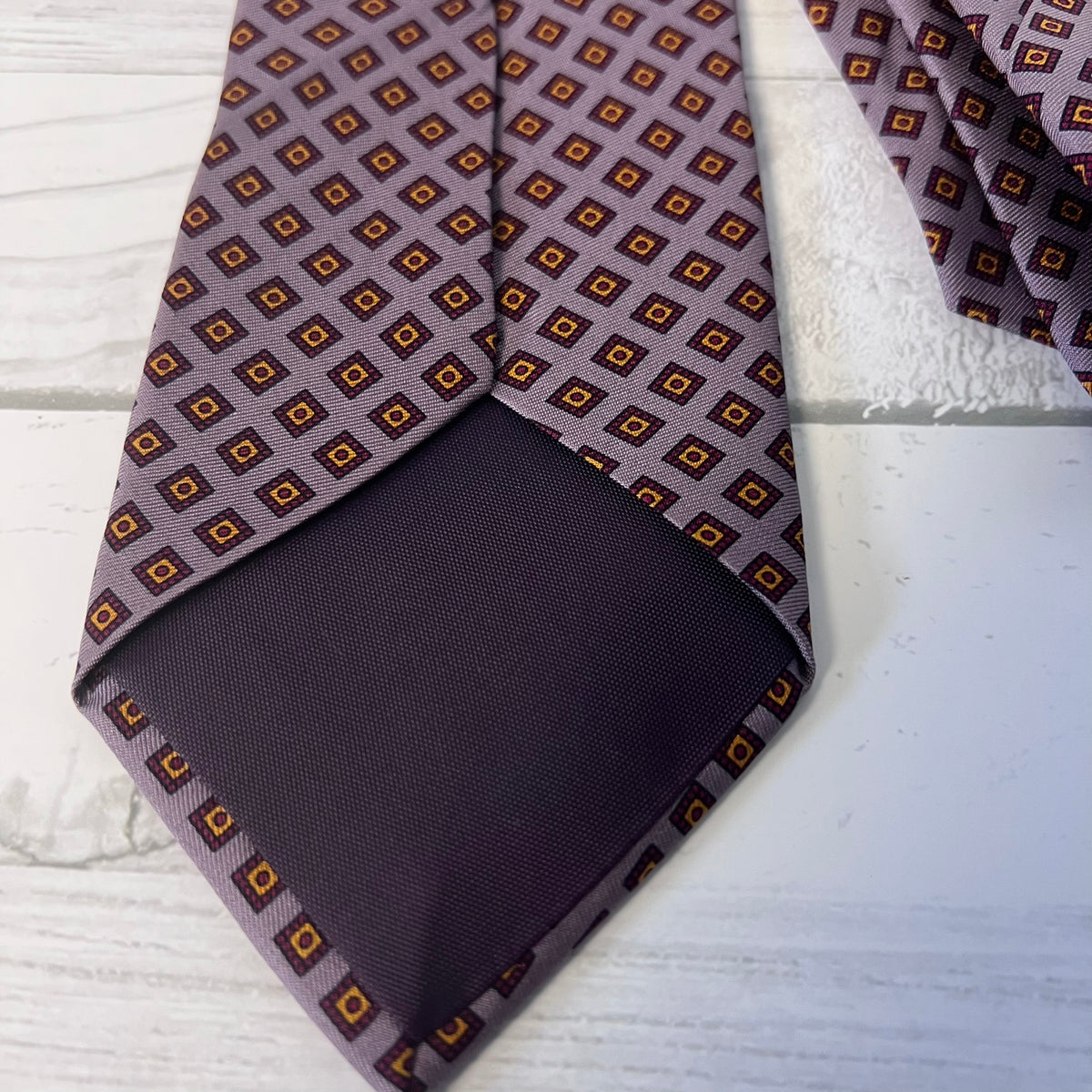 Patterned tie and pocket square on a textured surface