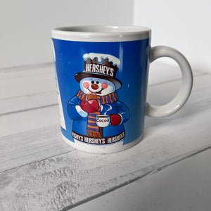 Hershey's snowman mug on a white wooden surface