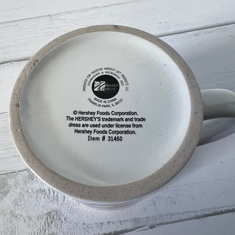 Ceramic mug with Hershey's branding on a light wooden surface