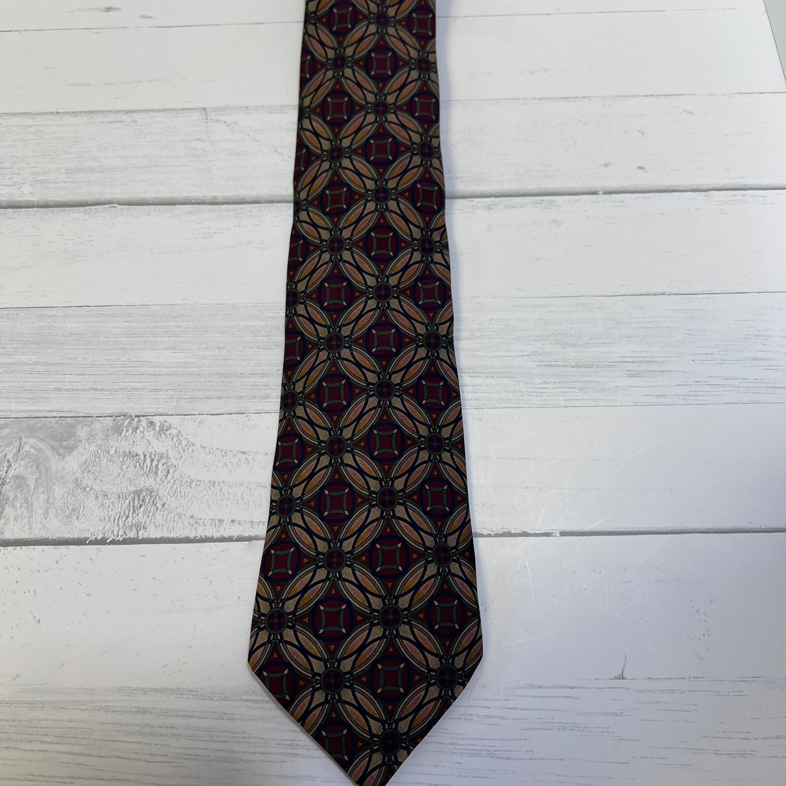Patterned tie on a light wooden surface