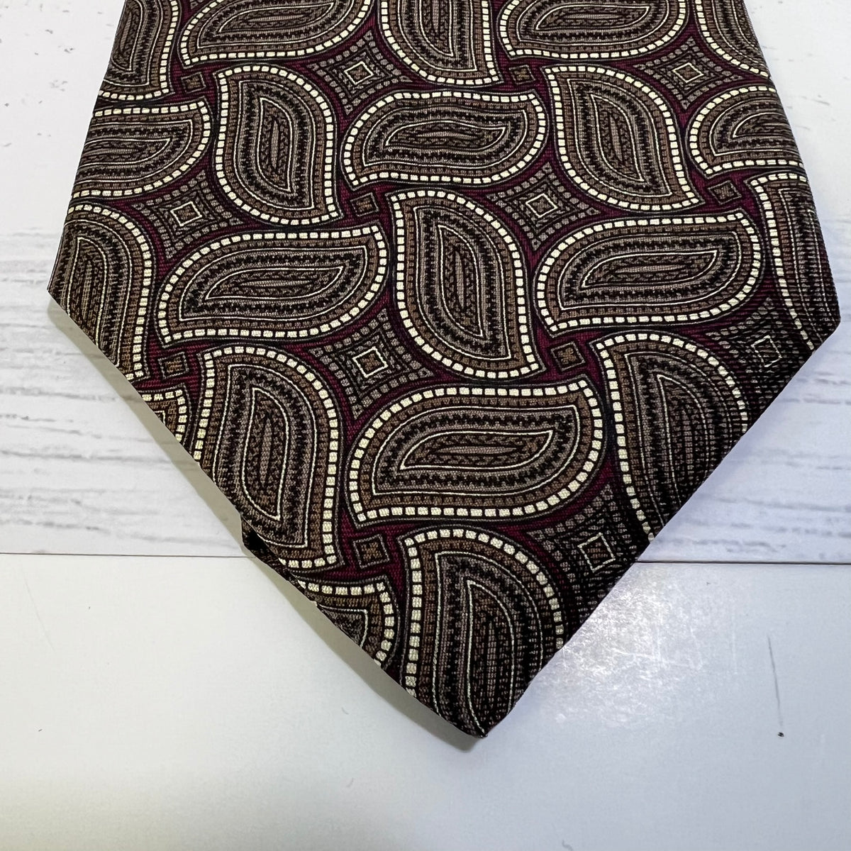 Patterned tie on a light wooden surface
