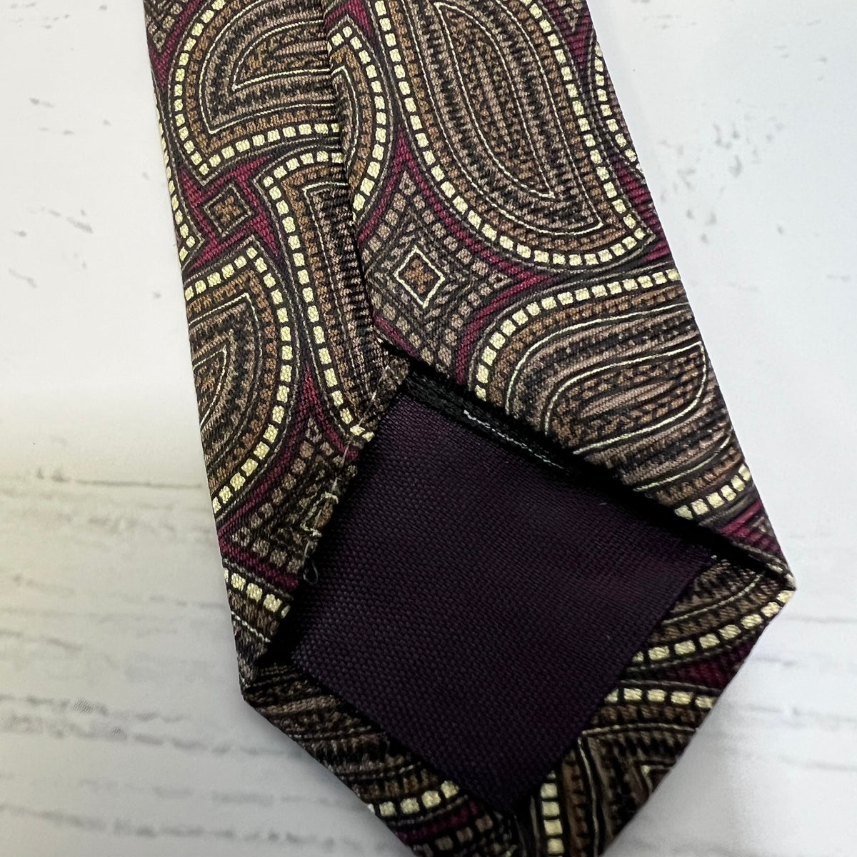 Patterned tie and pocket square on a textured surface