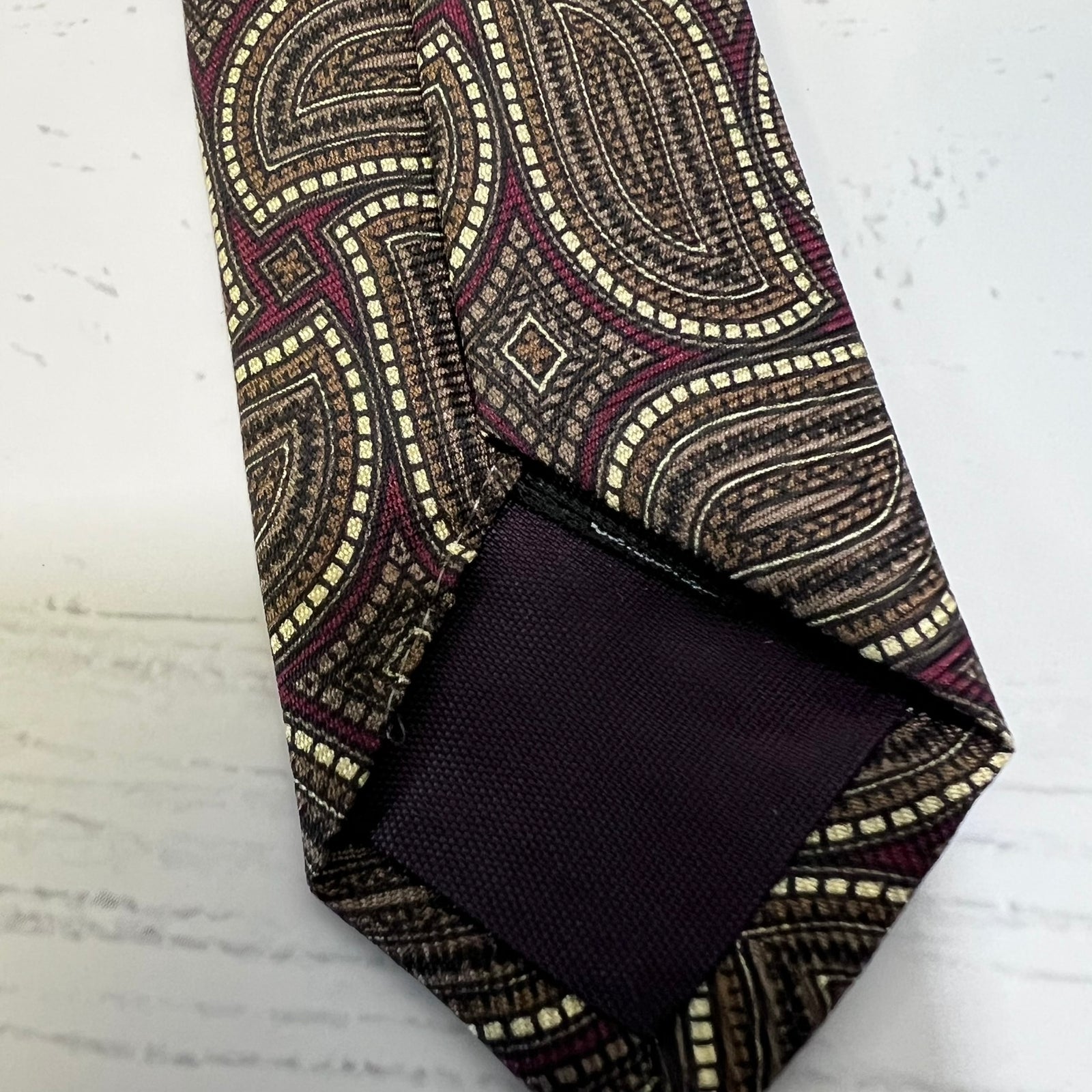 Patterned tie and pocket square on a textured surface