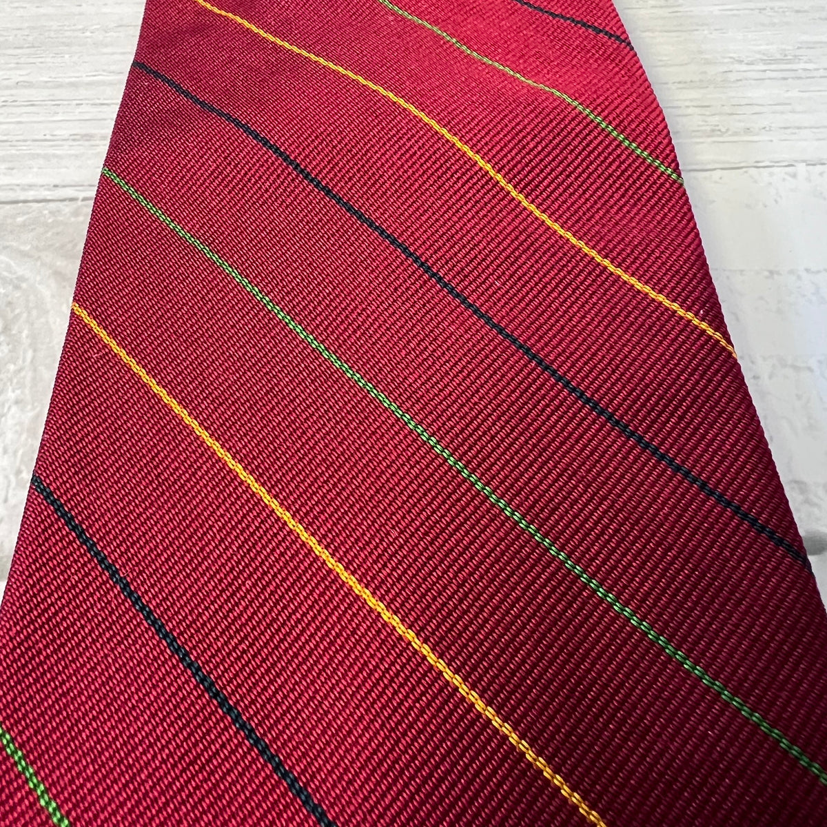Red tie with diagonal stripes on a white background