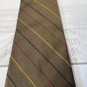 Brown tie with red and black diagonal stripes on a light wooden surface