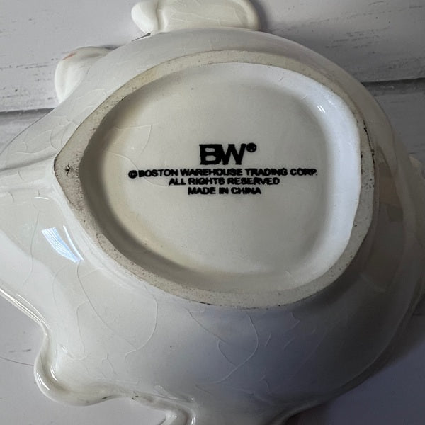 Back of a ceramic item with 'BW' branding and 'Boston Warehouse Trading Corp.' text.