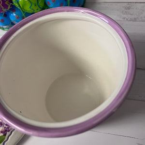 Purple-rimmed ceramic bowl on a wooden surface