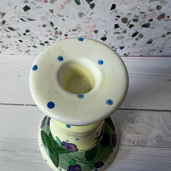 Decorative candle holder with floral design on a textured surface