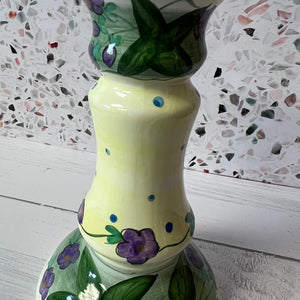 Decorative candle holder with floral patterns on a textured surface