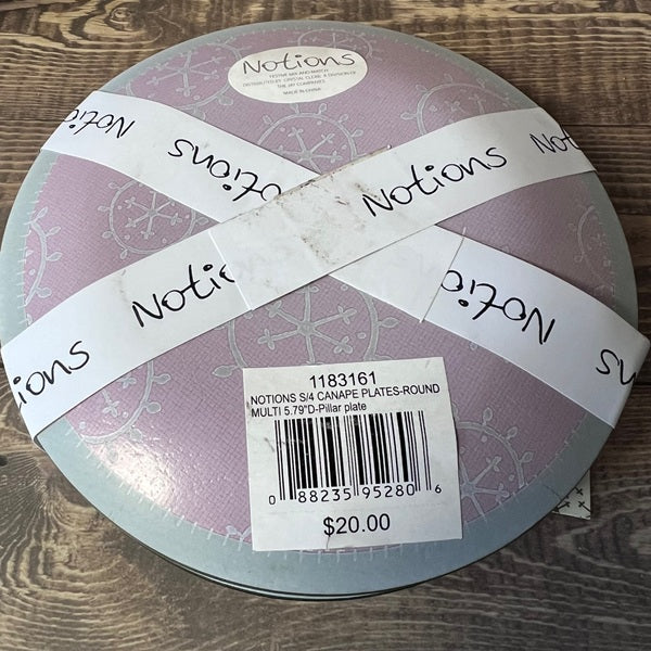 Round packaging with 'Notions' branding on a wooden surface
