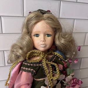 Vintage doll with blonde hair and detailed clothing against a tiled wall background