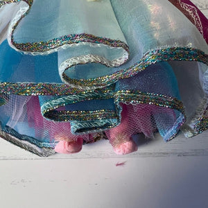 Close-up of colorful fabric with ribbons on a white surface
