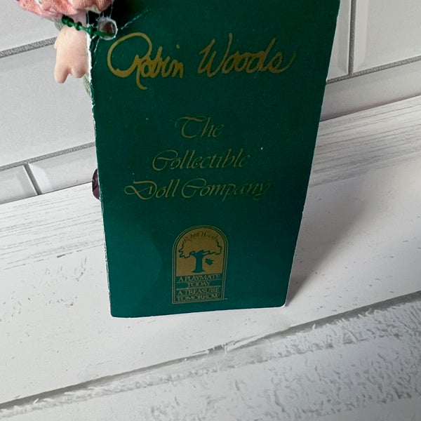 Green Robin Woods collectible doll company box on a white surface