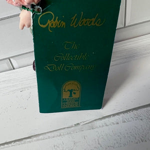 Green Robin Woods collectible doll company box on a white surface