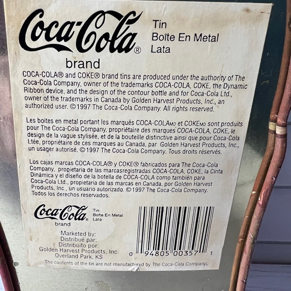 Coca-Cola brand label on a metal can with text and barcode