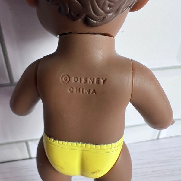 Toy figure with 'Disney China' branding on the back, wearing yellow underwear.