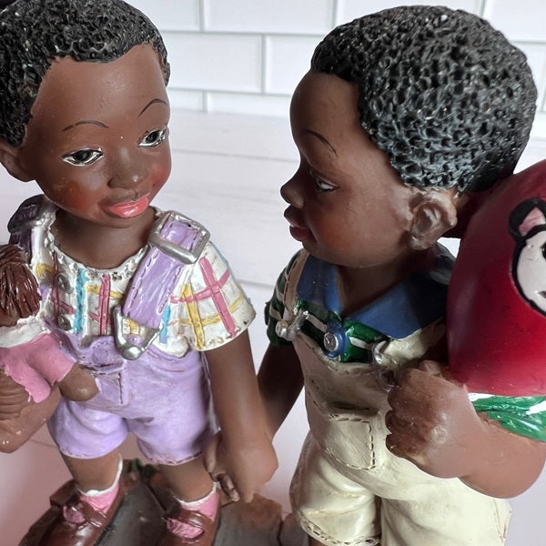 Two vintage dolls with detailed clothing and hairstyles against a white background