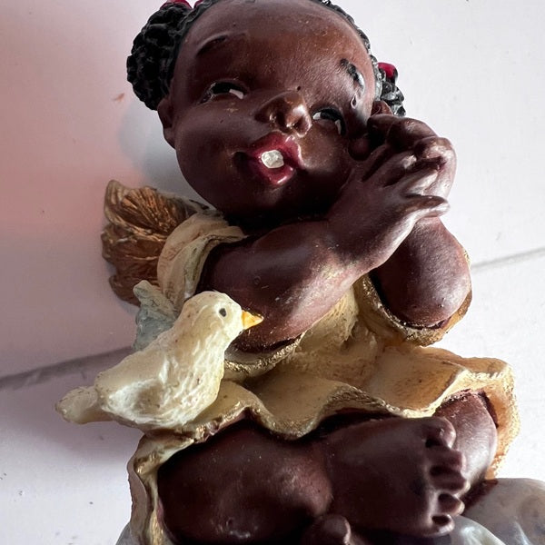 Statue of a child with a dove on a white background